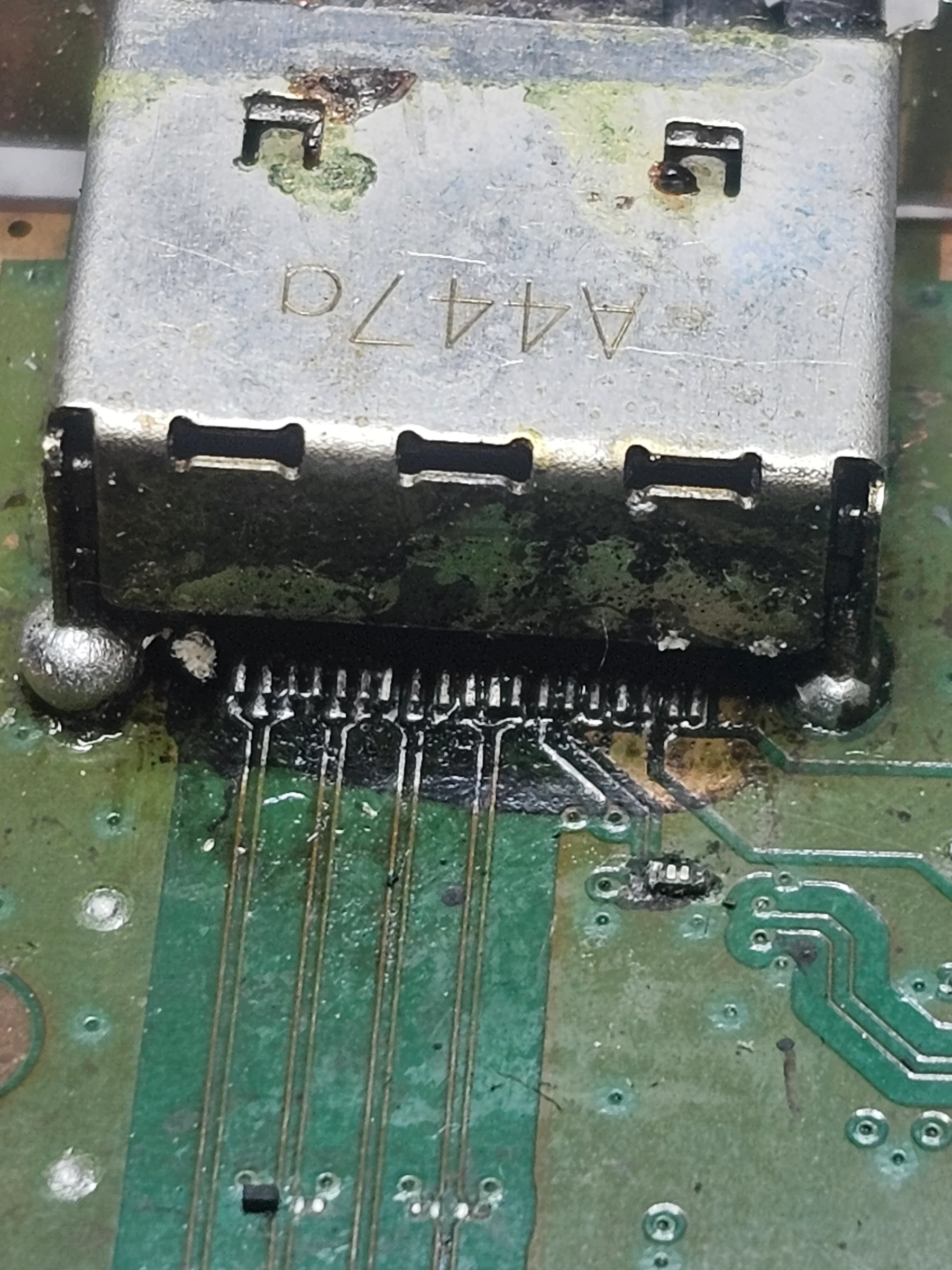 HDMI port area with damage from a previous repair attempt